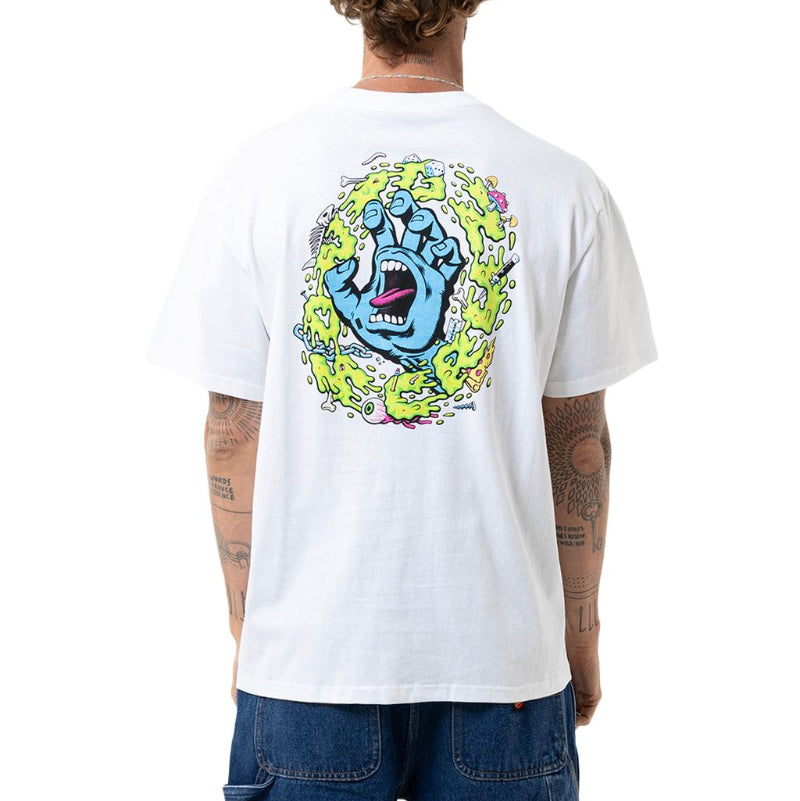 A man viewed from behind wearing a white graphic t-shirt with a large colorful print of a screaming hand on the back, paired with blue jeans against a white studio background.