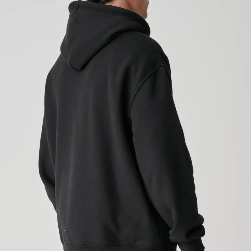 Person wearing a black hoodie from behind on a light gray background