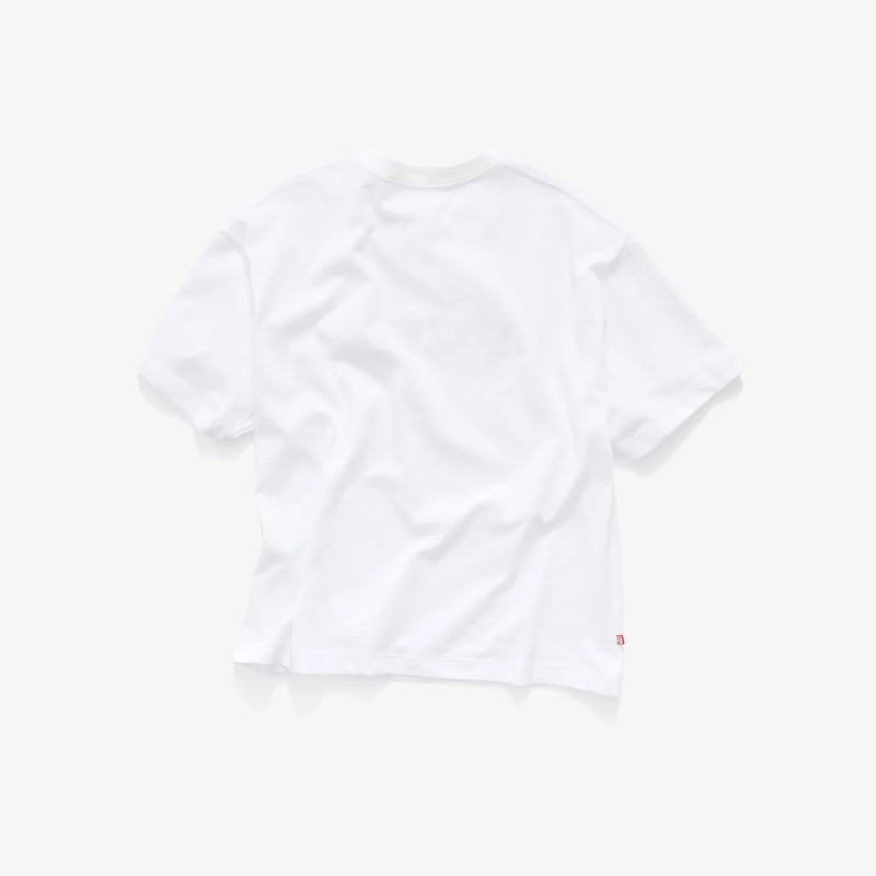 A white short-sleeve crewneck t-shirt shown from the back, featuring a faint tonal graphic and a small red tag on the lower right hem, set against a solid off-white background.