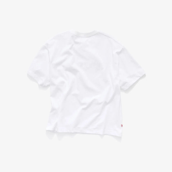 A white short-sleeve crewneck t-shirt shown from the back, featuring a faint tonal graphic and a small red tag on the lower right hem, set against a solid off-white background.