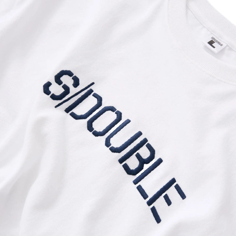 Close-up of a white crewneck t-shirt featuring the word 'SDOUBLE' printed diagonally across the chest in dark navy blue.