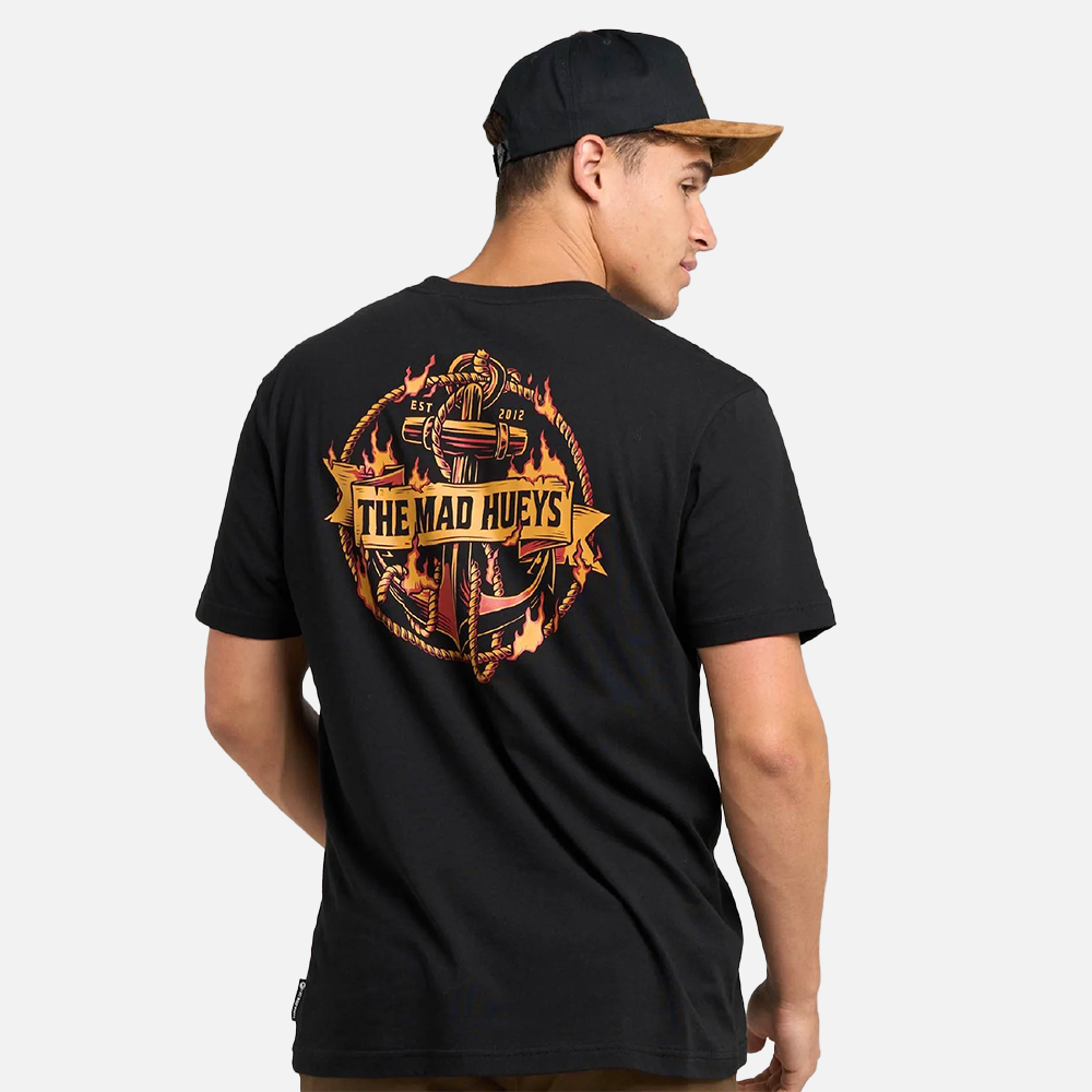 Person wearing a black t-shirt with 'The Mad Hueys' logo on the back, against a white background