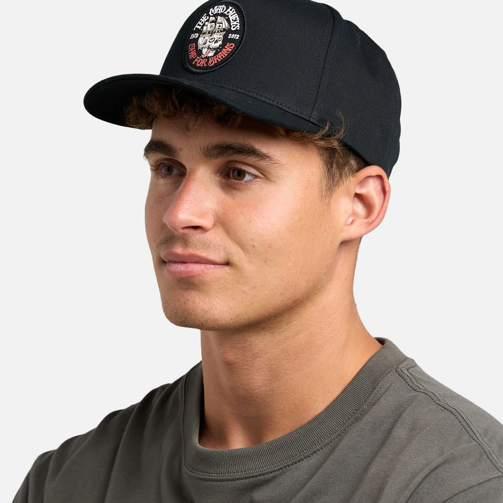 Man wearing a black cap with a logo on a white background