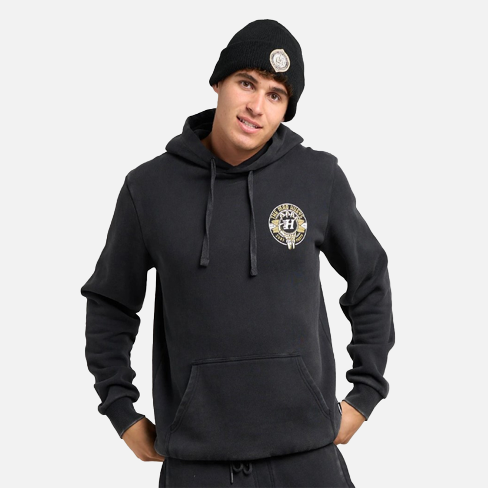 Person wearing a black hoodie with a logo on a light gray background