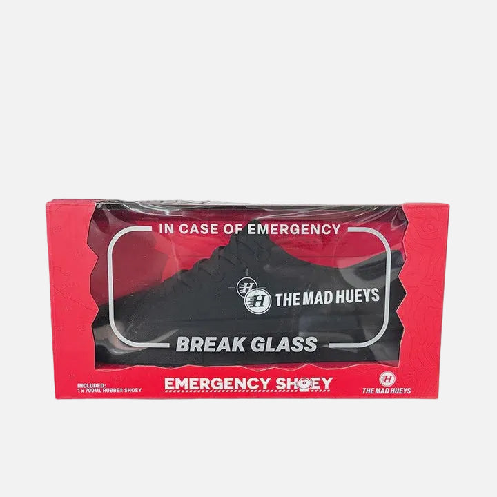 Black shoe in a red packaging box labeled 'In Case of Emergency' with 'The Mad Hueys' branding.