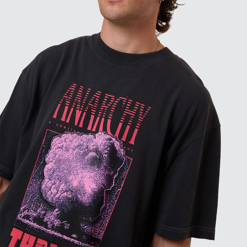 Person wearing a black t-shirt with pink and red graphics and text.