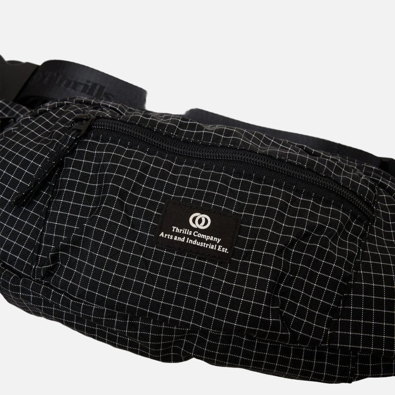 Black grid-patterned waist bag with a brand logo on a light gray background