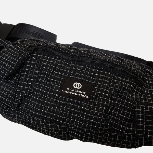 Black grid-patterned waist bag with a brand logo on a light gray background