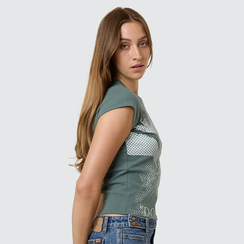Woman wearing a green sleeveless top with mesh design and denim skirt on a white background