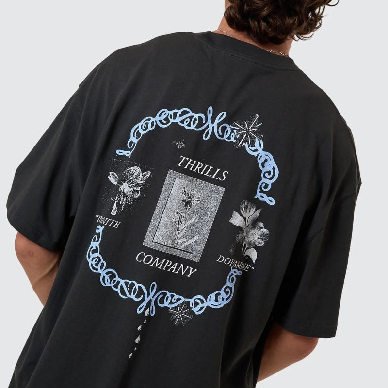Person wearing a black t-shirt with a decorative design and text on the back against a white background