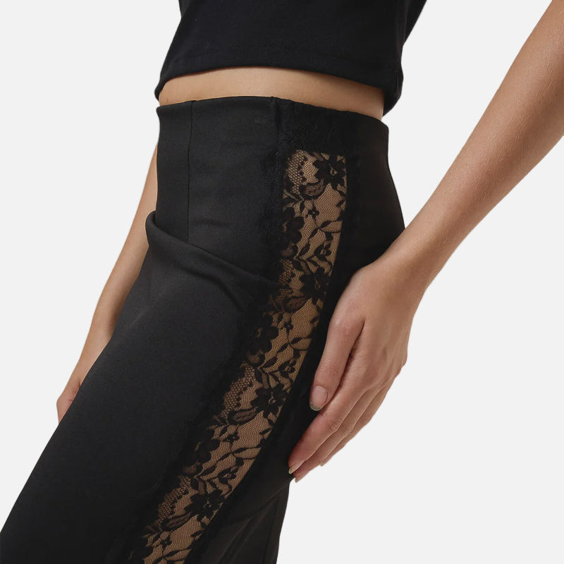 Black skirt with lace detailing on a plain background