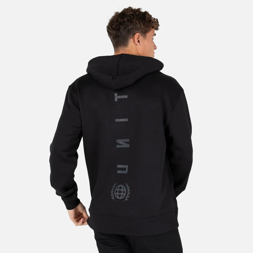 Person wearing a black hoodie with branding on the back against a light gray background