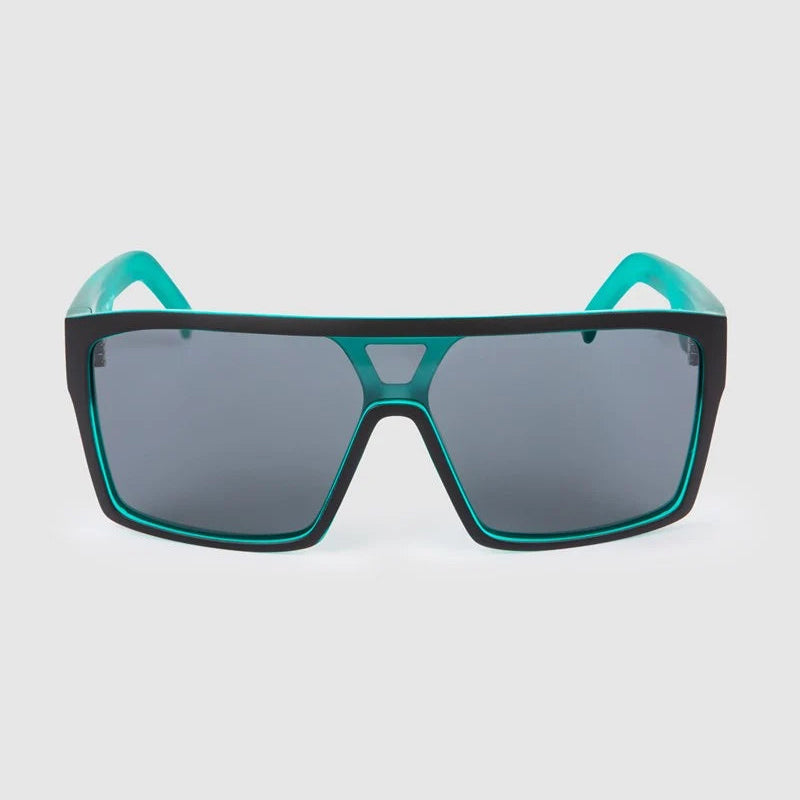 A pair of oversized shield-style sunglasses with a matte black frame and bright teal accents on the inner rims and temples, set against a light gray background.
