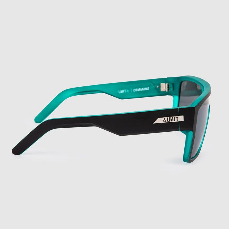 Side view of tactical sunglasses with a black front frame and teal arms, featuring a white logo on the temple.