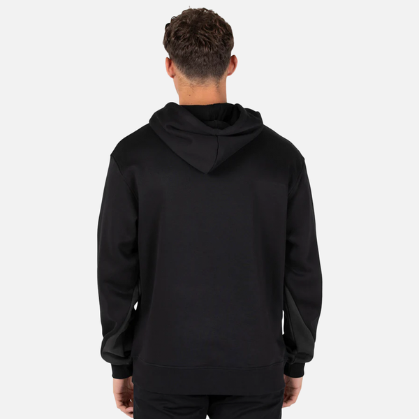 Person wearing a black hoodie from behind on a light gray background
