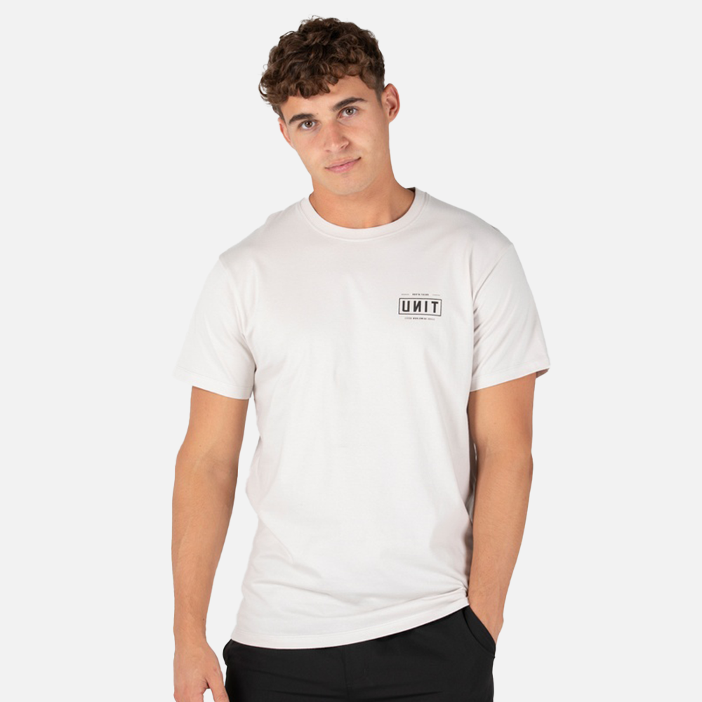 Person wearing a white t-shirt with a unit logo on a plain background