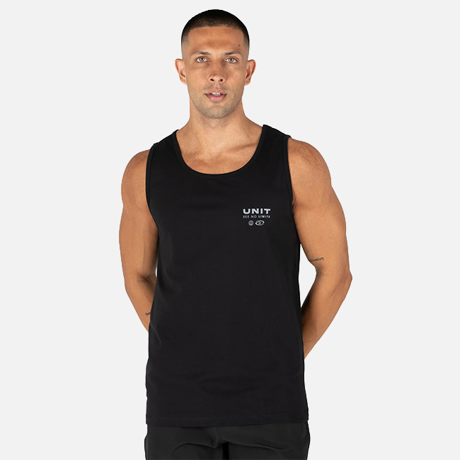 A man wearing a black sleeveless tank top with a small white 'UNIT' logo on the left chest, photographed against a light gray studio background.