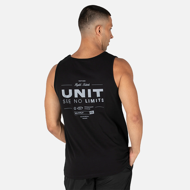 A man shown from the back wearing a black sleeveless tank top with a white graphic print that reads 'UNIT SEE NO LIMITS' and smaller text above, photographed against a light gray studio background.