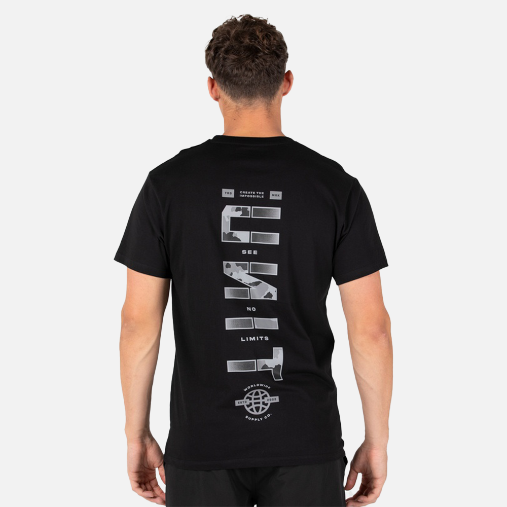 Person wearing a black unit t-shirt with white graphics on the back against a light gray background