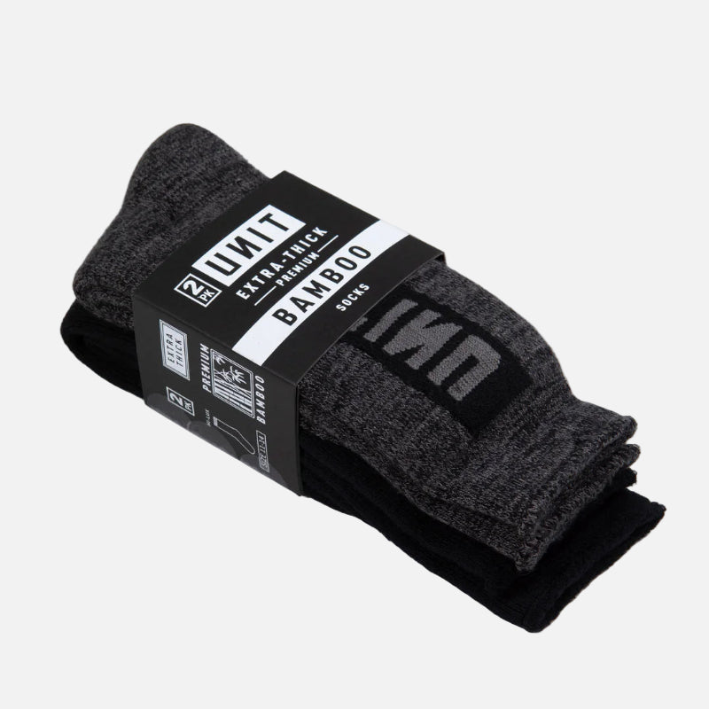 Pack of black socks with a label on a light gray background
