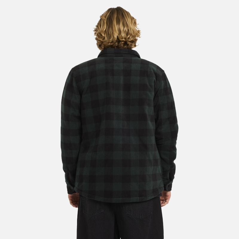 Person wearing a black and green plaid shirt on a white background