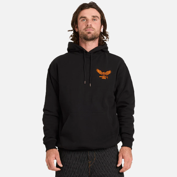 Man wearing a black hoodie with an eagle logo on a white background