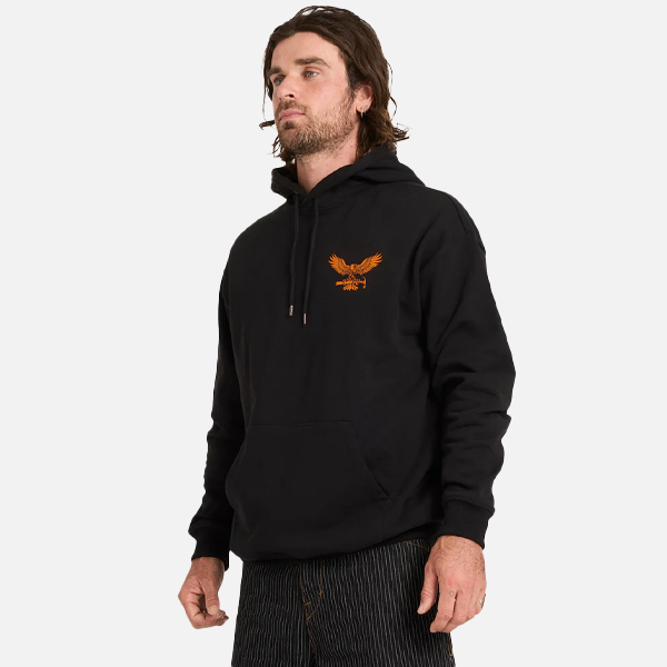 Man wearing a black hoodie with an eagle logo on a white background