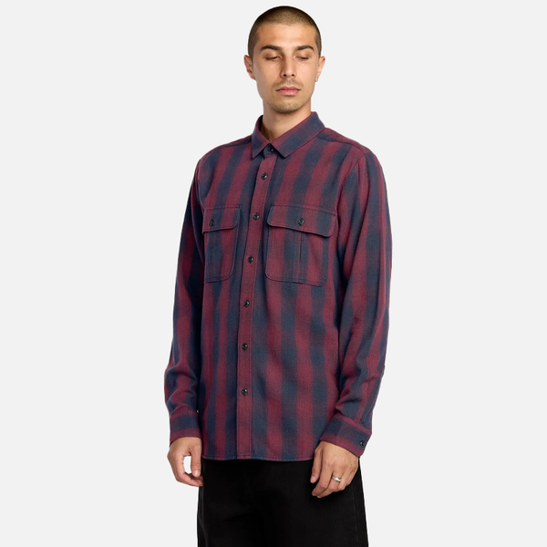 Man wearing a red and blue plaid shirt on a white background