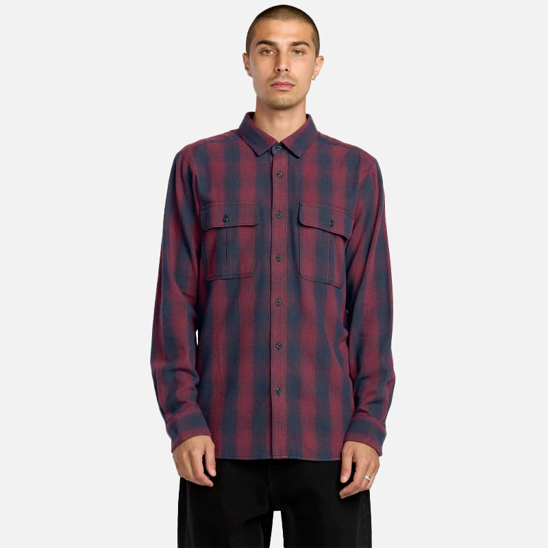 Man wearing a red and blue plaid shirt on a white background