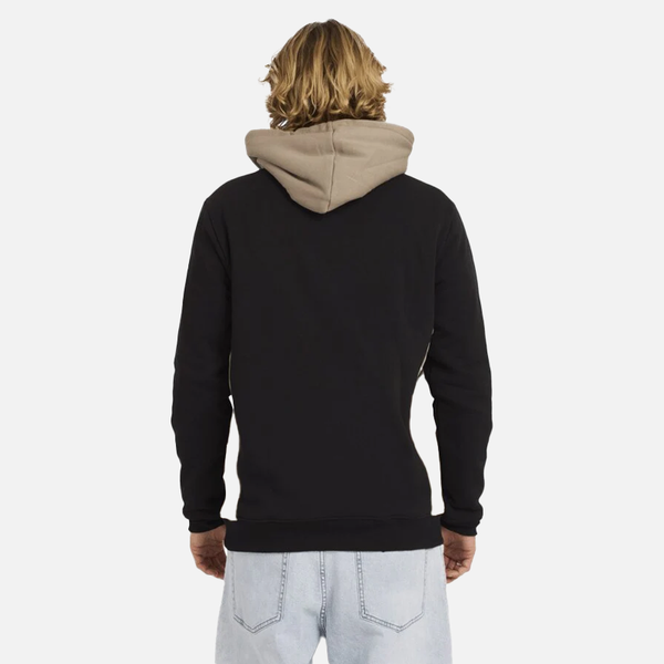 Person wearing a black hoodie with beige hood on a white background