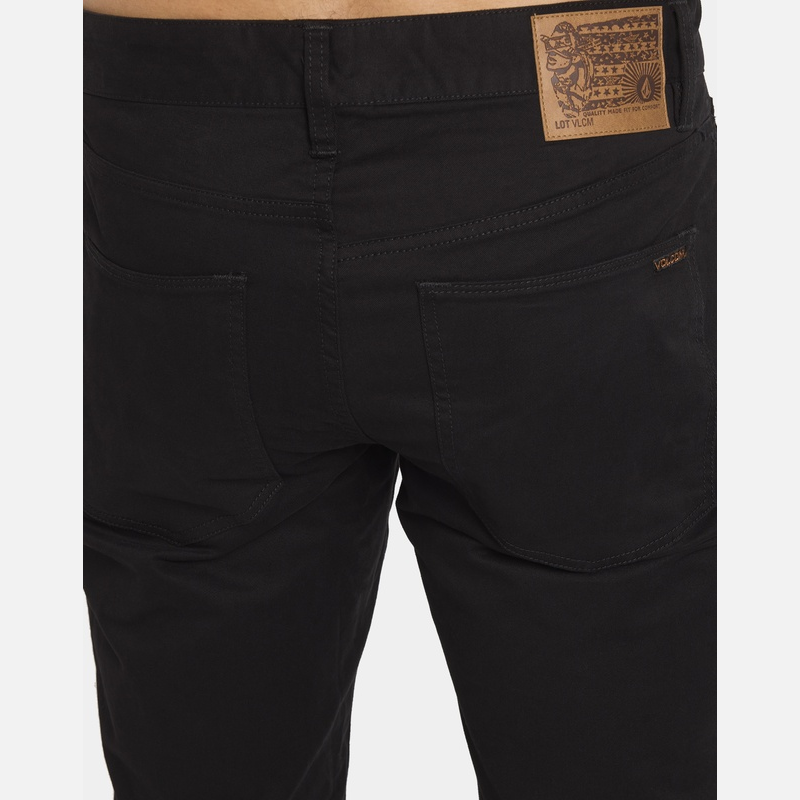 Black pants with a brand label on a white background