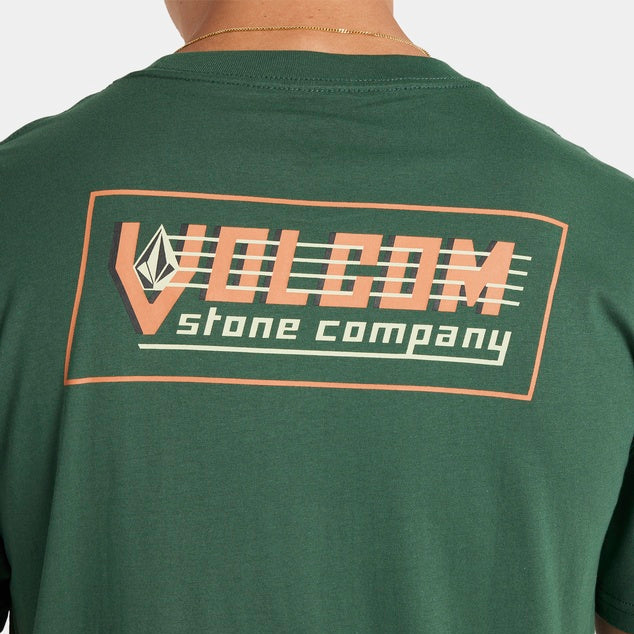 Green t-shirt with Volcom logo on the back against a neutral background