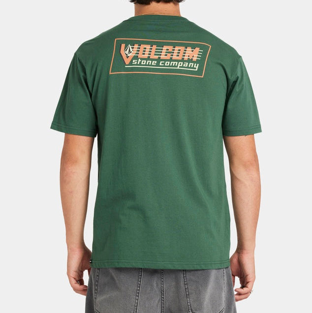 Person wearing a green Volcom t-shirt with branding on the back against a white background