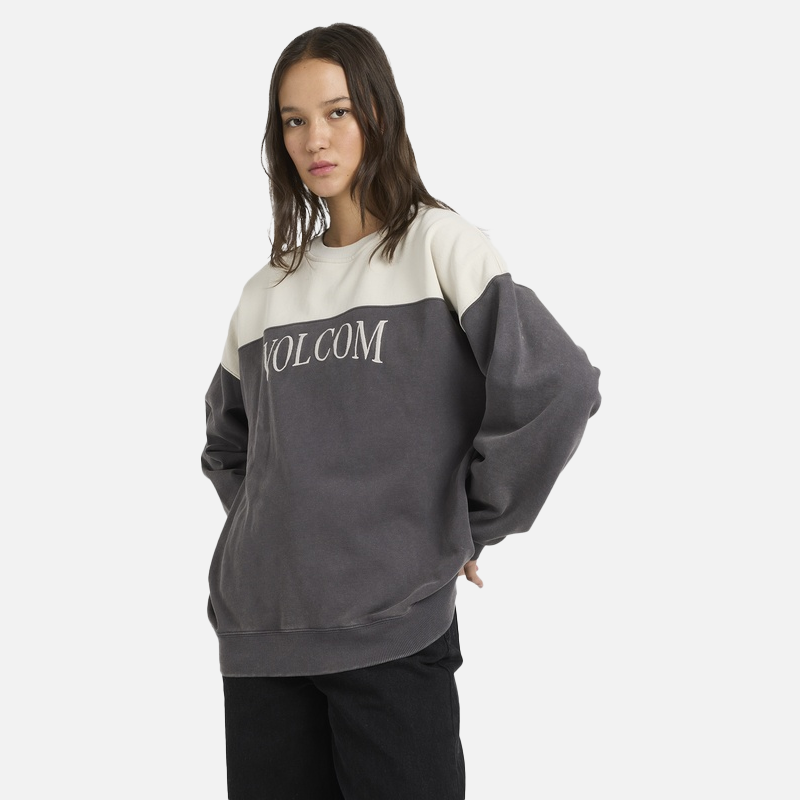 Person wearing a Volcom sweatshirt on a white background