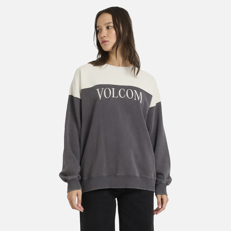 Person wearing a Volcom sweatshirt on a white background