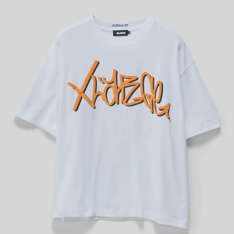 A white short-sleeve t-shirt with a large orange graffiti-style graphic reading 'XLARGE' across the chest, displayed on a neutral light gray background.
